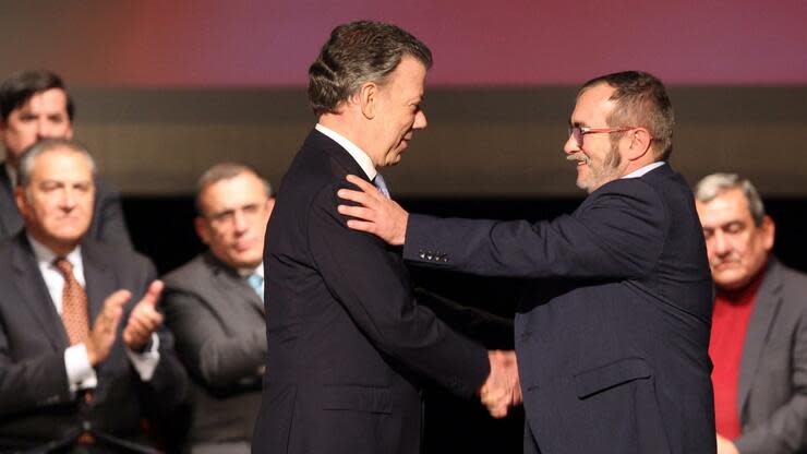 Farc-Parteichef Rodrigo Londoño (rechts) beim Händeschütteln mit dem damaligen Präsidenten Juan Manuel Santos, nachdem sie den Friedensvertrag unterschrieben haben. Foto: dpa