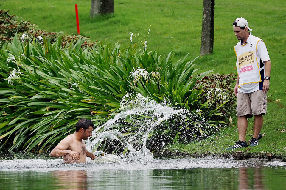 KUALA LUMPUR, MALAYSIA - APRIL 18:  Spain's Pablo Larrazabal jumps into a water hazard in an attempt to avoid attacking hornets during round two of the 2014  Maybank Malaysian Open at Kuala Lumpur Golf & Country Club on April 18, 2014 in Kuala Lumpur, Malaysia.  (Photo by Getty Images)