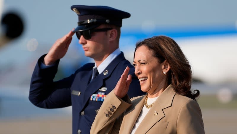 Vice President Kamala Harris, right, salutes upon arrival at Andrews Air Force Base in Md., Saturday, July 27, 2024. The Harris campaign is expected to reveal Harris’ running mate within a week.