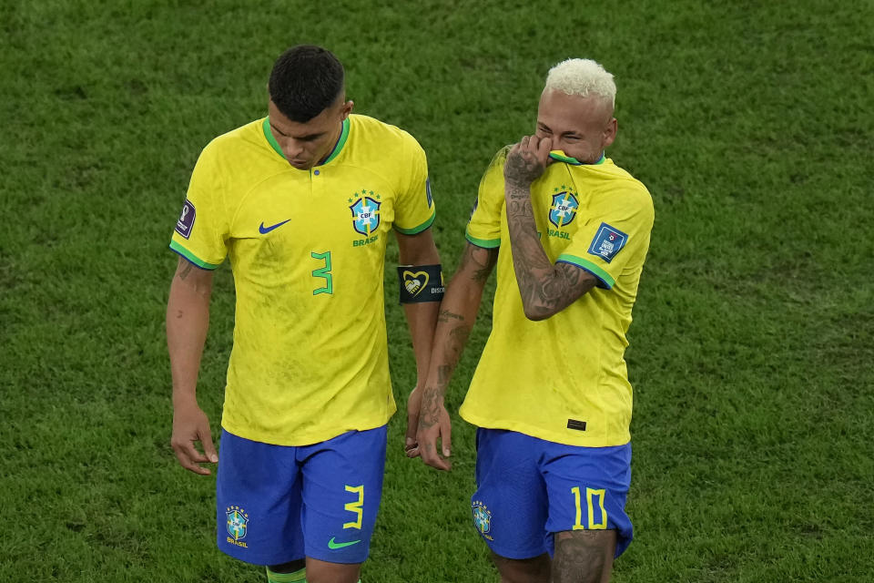 Brazil's Neymar, right, cries as he walks off the field with teammate Thiago Silva after their loss in the World Cup quarterfinal soccer match against Croatia, at the Education City Stadium in Al Rayyan, Qatar, Friday, Dec. 9, 2022. (AP Photo/Alessandra Tarantino)