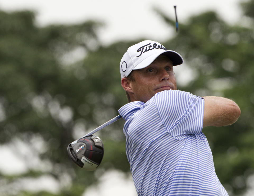 FILE - In this Oct. 12, 2018, file photo, Nick Watney, of the United States, follows his shot on the eighteenth hole during round two of the CIMB Classic golf tournament at Tournament Players Club (TPC) in Kuala Lumpur, Malaysia. Watney became the first PGA Tour player to test positive for COVID-19. He withdrew from the RBC Heritage on Friday, June 19, 2020. (AP Photo/Yam G-Jun, File)