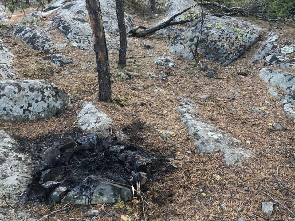 A picture of the remnants of an illegal campfire near the Frame Lake trail. A woman in the area has twice discovered people having illegal fires in the area.  (Emily Jean - image credit)