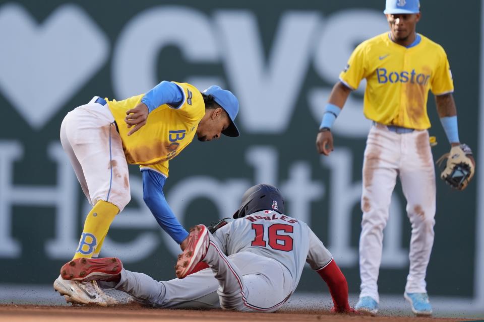 Boston Red Sox second baseman David Hamilton, left, tags Washington Nationals' Victor Robles (16) who was attempting to steal second during the eighth inning of a baseball game, Saturday, May 11, 2024, in Boston. (AP Photo/Michael Dwyer)