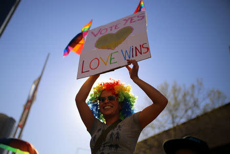 A woman holds up a placard during a march for marriage equality of same-sex couples in Sydney, Australia, September 10, 2017. REUTERS/Steven Saphore