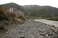 Buildings which were damaged in the 2008 Sichuan earthquake stand alongside a dry riverbed in the city of Beichuan, Sichuan province, China, April 6, 2018. REUTERS/Jason Lee