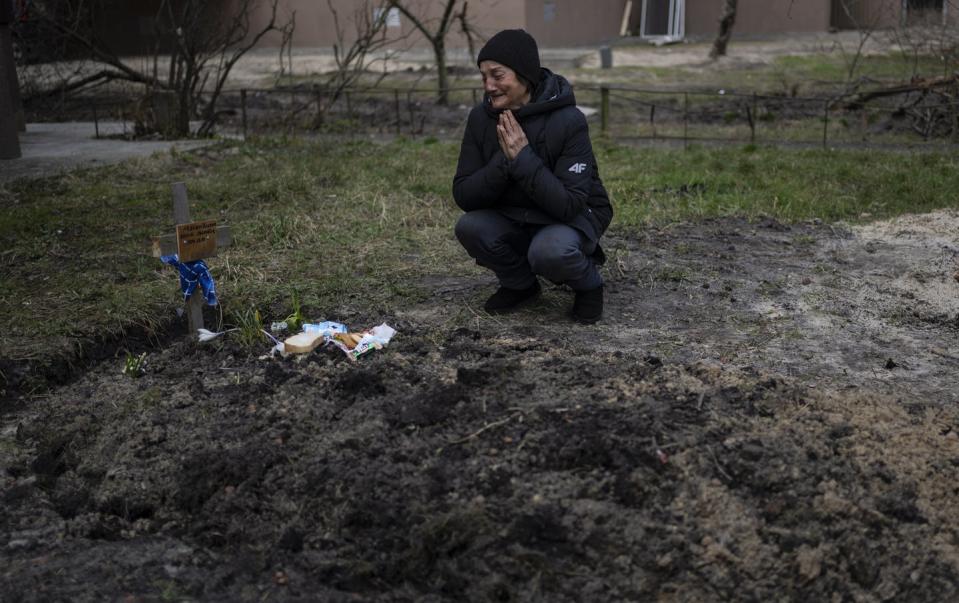 <span class="caption">Tanya Nedashkivs'ka, 57, mourns the death of her husband at the site where he was buried in Bucha, on the outskirts of Kyiv, Ukraine, Monday, April 4, 2022.</span> <span class="attribution"><a class="link " href="https://newsroom.ap.org/detail/Russia%20Ukraine%20War%20A%20Walk%20Through%20Bucha/83871abfbfa443a9879330e65b3c5524?Query=ukraine%20bury&mediaType=photo&sortBy=arrivaldatetime:desc&dateRange=Anytime&totalCount=163&currentItemNo=31" rel="nofollow noopener" target="_blank" data-ylk="slk:AP Photo/Rodrigo Abd;elm:context_link;itc:0;sec:content-canvas">AP Photo/Rodrigo Abd</a></span>