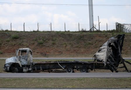 A burned truck is seen after an armed gang robbed a securities company at the Viracopos airport freight terminal, in Campinas