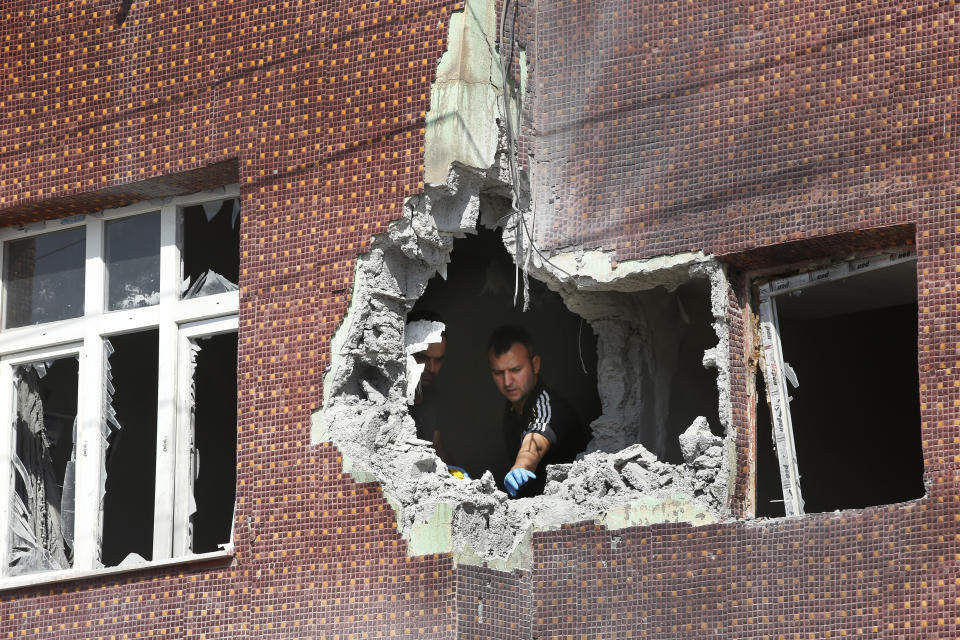 A police forensic officer collects evidence from a building damaged by a mortar fired from inside Syra, in Akcakale, Sanliurfa province, southeastern Turkey, Oct. 13, 2019. (Photo: Lefteris Pitarakis/AP)