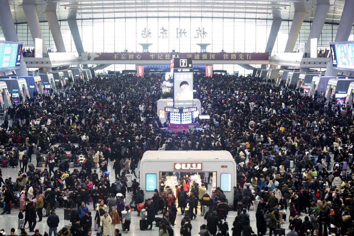 Passengers wait for their trains at the Hangzhou East Railway Station: AP