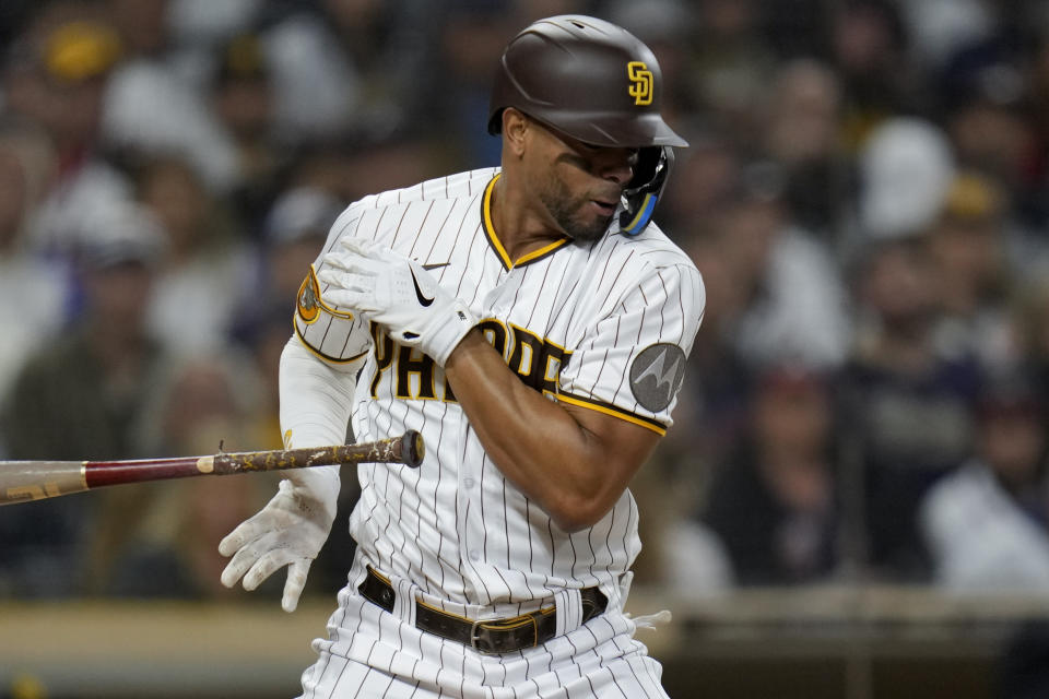 San Diego Padres' Xander Bogaerts reacts after being hit in the hand while batting during the fourth inning of a baseball game against the Atlanta Braves, Tuesday, April 18, 2023, in San Diego. (AP Photo/Gregory Bull)