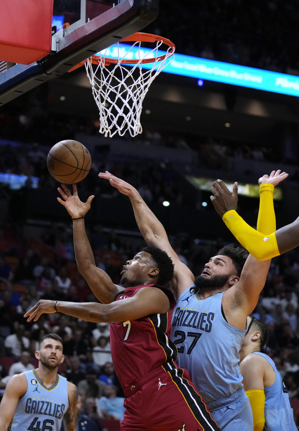 Miami Heat guard Kyle Lowry (7) shoots under pressure from Memphis Grizzlies forward David Roddy (27) during the first half of an NBA basketball game Wednesday, March 15, 2023, in Miami. (AP Photo/Rebecca Blackwell)
