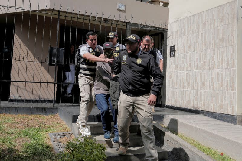 Police officers escort Nicanor Boluarte, brother of Peruvian President Dina Boluarte, in Lima