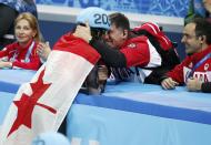 Charles Hamelin (L) of Canada celebrates his victory in the men's 1,500 metres short track speed skating finals event at the Iceberg Skating Palace during the 2014 Sochi Winter Olympics February 10, 2014. REUTERS/Lucy Nicholson (RUSSIA - Tags: SPORT SPEED SKATING OLYMPICS)