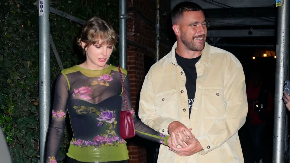 (From left) Taylor Swift and Travis Kelce holding hands in New York City in October. - Gotham/GC Images/Getty Images