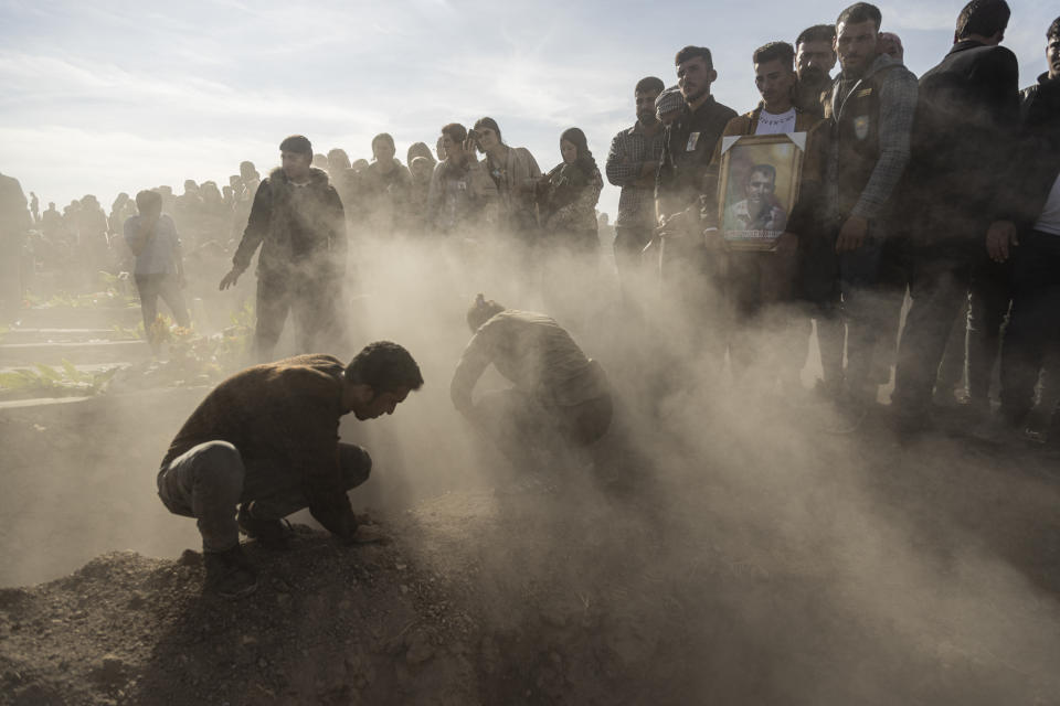 Syrian Kurds attend a funeral of people killed in Turkish airstrikes in the village of Al Malikiyah , northern Syria, Monday, Nov. 21, 2022. The airstrikes, which Turkey said were aimed at Kurdish militants whom Ankara blamed for a deadly Nov. 13 bombing in Istanbul, also struck several Syrian army positions in three different provinces along the border with Turkey. (AP Photo/Baderkhan Ahmad)