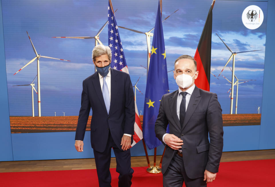 German Foreign Minister Heiko Maas, right, and the US' Special Presidential Envoy for Climate John Kerry, left, pose prior to a meeting at the Foreign Office in Berlin on Tuesday, May 18, 2021. (Odd Andersen/Pool Photo via AP)