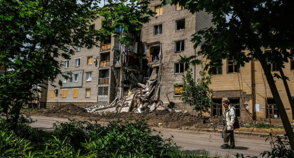 A woman walks past a destroyed building. The city of Bakhmut, called Artemivsk from 1924 until 2016, is the administrative center of Bakhmut district and is located in the Donetsk region. Located on the Bakhmutka River, tributary of the Donets River, has about 80.000 inhabitants. During the last weeks suffered several attacks and shelling from Russian army, the majority of the population left the city, the frontline is only 8 km away. (Photo by Rick Mave / SOPA Images/Sipa USA)