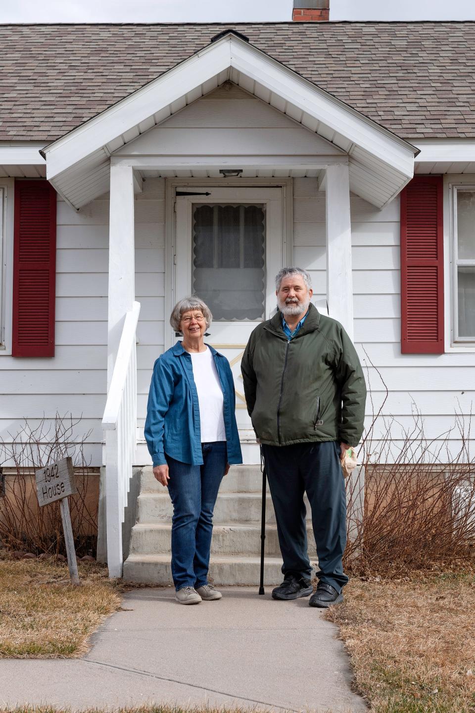 Bob Bee and Liz (Bee) Harrison pose in front of the 1942 home they grew up in on the Bee Family Centennial Farm Museum in Fort Collins on Feb. 15.