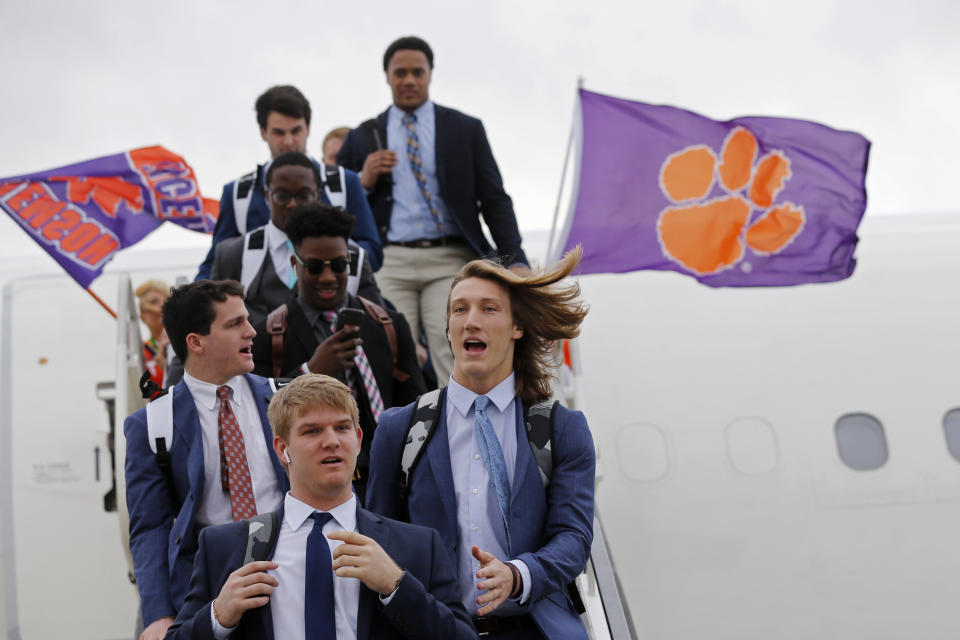Clemson quarterback Trevor Lawrence, right front, arrives with the team in New Orleans for the NCAA College Football Playoff title game, Friday, Jan. 10, 2020. Clemson is scheduled to play LSU on Monday. (AP Photo/Gerald Herbert)