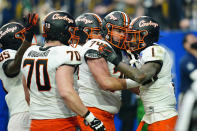 Oklahoma State wide receiver Tay Martin (1) celebrates his touchdown against Notre Dame with teammates during the second half of the Fiesta Bowl NCAA college football game, Saturday, Jan. 1, 2022, in Glendale, Ariz. (AP Photo/Ross D. Franklin)