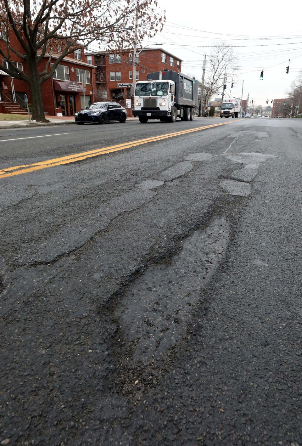 A large pothole is pictured along the heavily traveled Yonkers Avenue in Yonkers, Jan 25, 2022. 