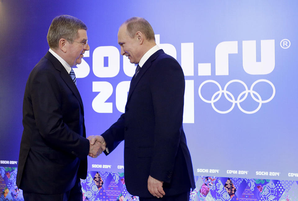 Russian President Vladimir Putin, right, greets International Olympic Committee President Thomas Bach at an event welcoming IOC members ahead of the upcoming 2014 Winter Olympics at the Rus Hotel, Tuesday, Feb. 4, 2014, in Sochi, Russia. (AP Photo/David Goldman, Pool)