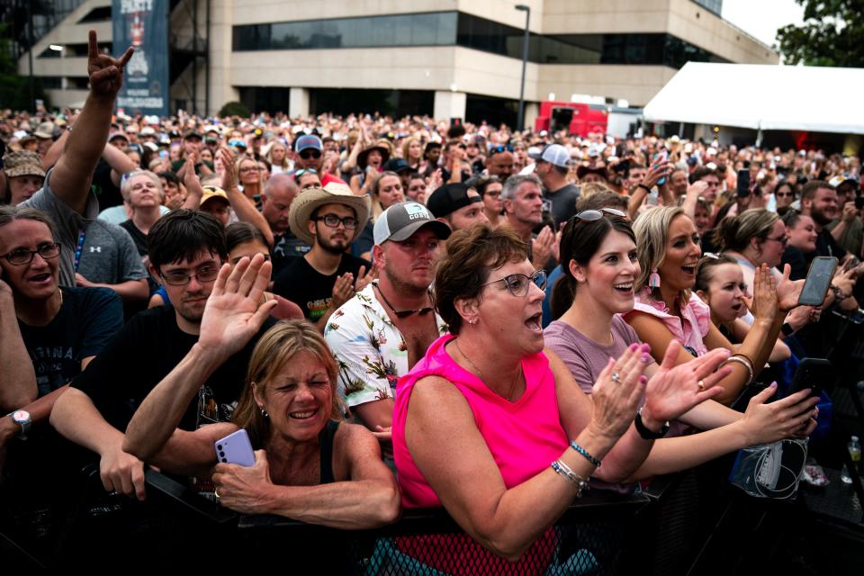 Fans watch as Luke Combs performs during a concert in the parking lot at BMI Nashville in Nashville, Tenn., Wednesday, June 8, 2022. The concert celebrated his nine consecutive number one songs.