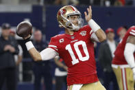 San Francisco 49ers quarterback Jimmy Garoppolo (10) passes against the Dallas Cowboys during the first half of an NFL wild-card playoff football game in Arlington, Texas, Sunday, Jan. 16, 2022. (AP Photo/Roger Steinman)