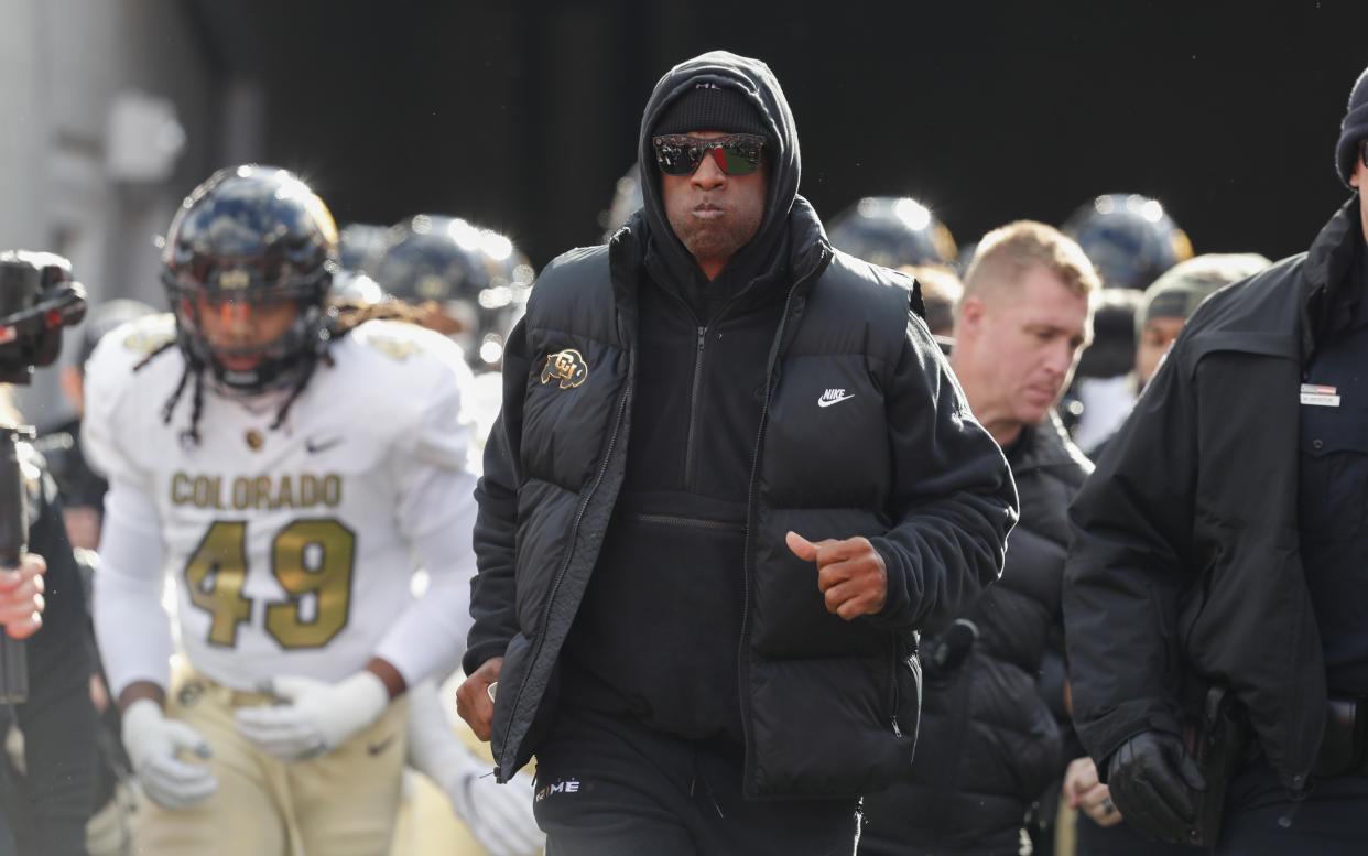 SALT LAKE CITY, UT - NOVEMBER 25: Deion Sanders head coach of the Colorado Buffaloes leads his team onto the field before the start of their game agaisnt the Utah Utes at Rice Eccles Stadium on November 25, 2023 in Salt Lake City, Utah.  (Photo by Chris Gardner/Getty Images)