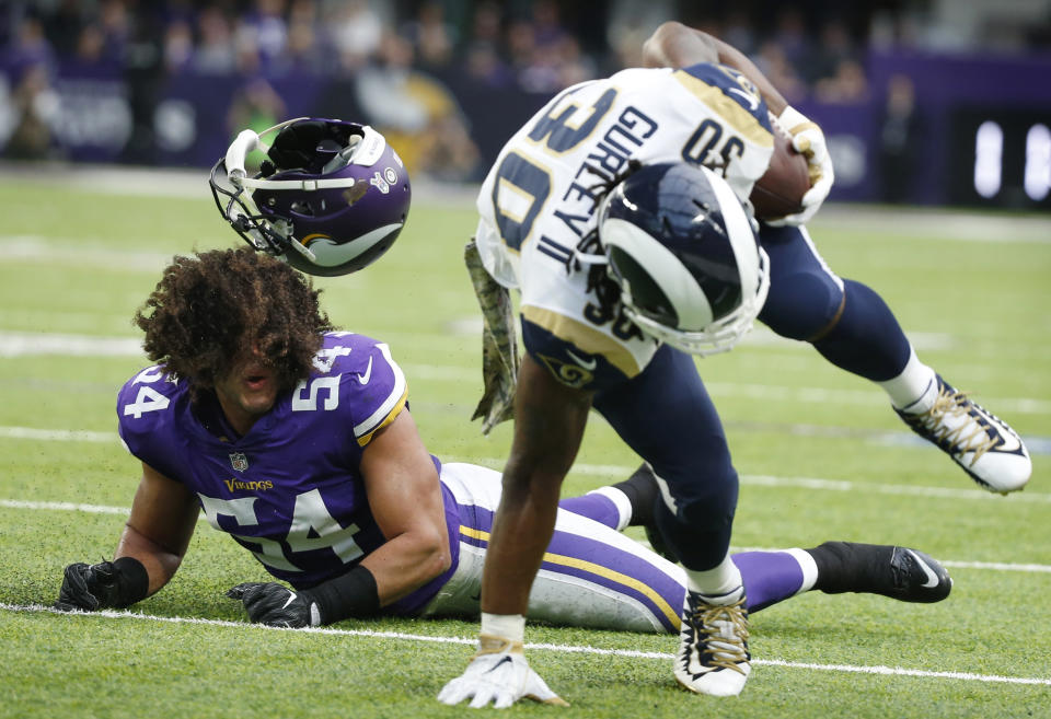 <p>Minnesota Vikings middle linebacker Eric Kendricks, left, loses his helmet as he chases Los Angeles Rams running back Todd Gurley (30) during the first half of an NFL football game, Sunday, Nov. 19, 2017, in Minneapolis. (AP Photo/Bruce Kluckhohn) </p>