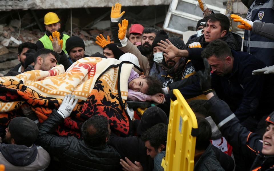 A girl is carried from a collapsed building in Diyarbakir, Turkey - Reuters/Sertac Kayar