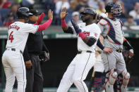 Cleveland Guardians' Brayan Rocchio, left, and Estevan Florial, right, celebrate near Detroit Tigers catcher Carson Kelly after scoring on a single by José Ramírez during the second inning of a baseball game Tuesday, May 7, 2024, in Cleveland. (AP Photo/Sue Ogrocki)