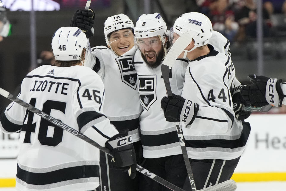 Los Angeles Kings defenseman Drew Doughty celebrates with center Blake Lizotte (46), center Trevor Moore (12) and defenseman Mikey Anderson (44) after scoring a goal against the Arizona Coyotes during the third period of an NHL hockey game Friday, Oct. 27, 2023, in Tempe, Ariz. (AP Photo/Rick Scuteri)