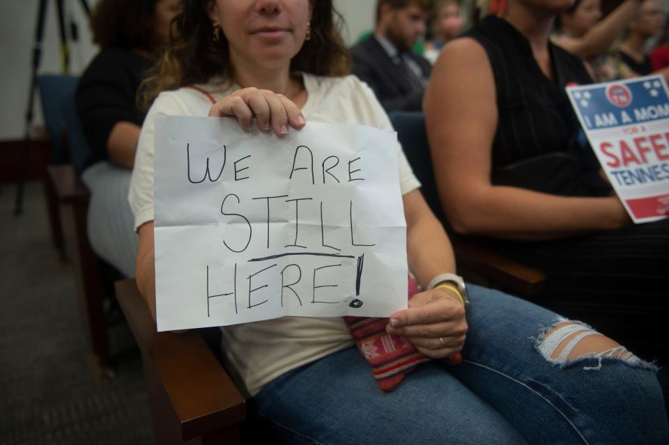 Supporters of gun safety reform hold signs during committee meetings at Cordell Hull State Office Building on Wednesday, Aug. 23, 2023, in Nashville, Tenn.