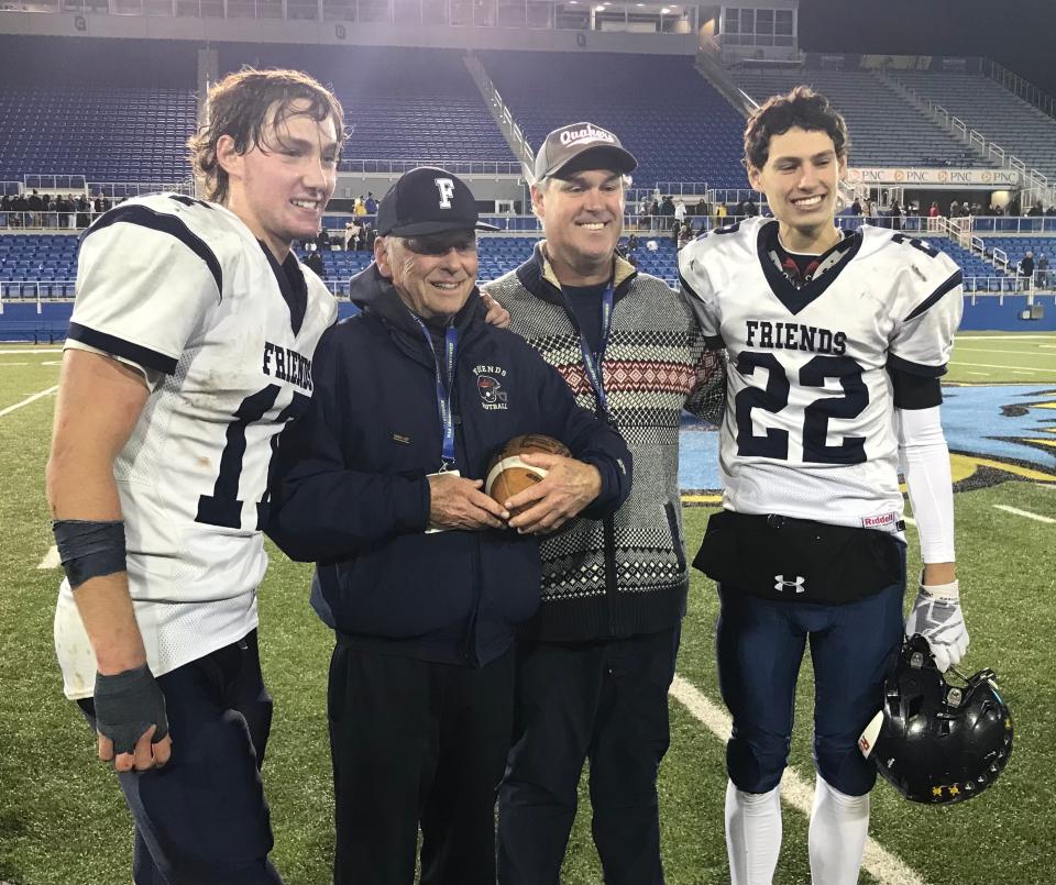 Wilmington Friends quarterback Robby Tattersall (left), associate head coach Bob Tattersall, head coach Rob Tattersall and defensive back Ryan Tattersall celebrate after the Quakers won the DIAA Class 2A football championship on Dec. 10 at Delaware Stadium.