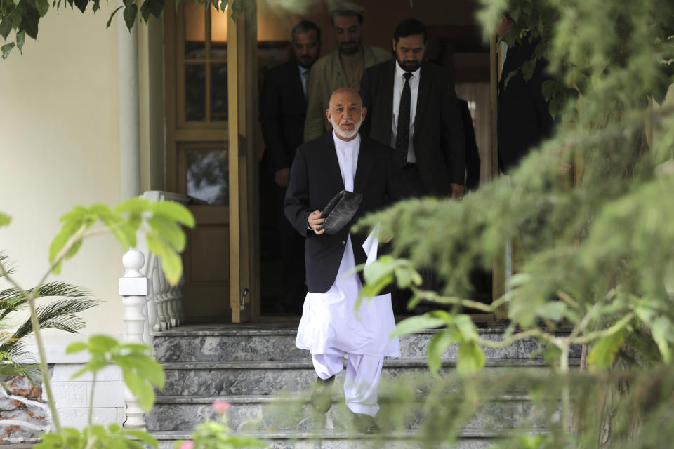 Afghanistan's former President Hamid Karzai arrives for a news conference in Kabul, Afghanistan, Tuesday, July 13, 2021. Former President Karzai calls on both the Afghan government and the Taliban to resume negotiations and end fighting in the country. (AP Photo/Rahmat Gul)
