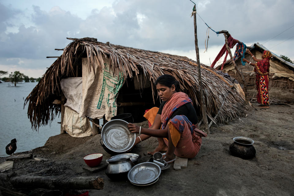 Una mujer lava los platos cerca de su refugio improvisado después de ver sus casas destruidas por el ciclón amphan. (Foto de Mushfiqul Alam/NurPhoto vía Getty Images) 