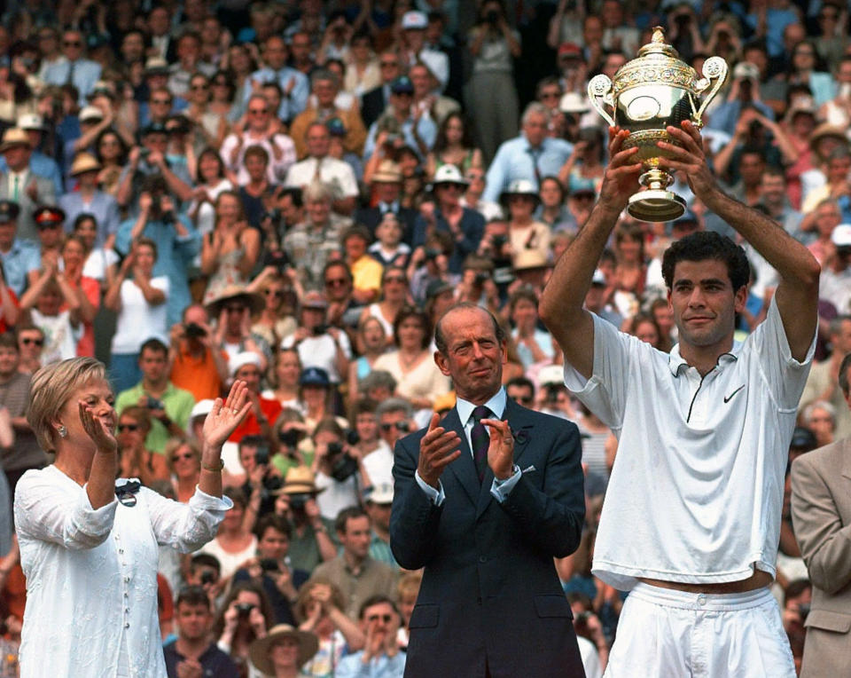 FILE - In this July 6, 1977, file photo, the Duke and Duchess of Kent applaud as Pete Sampras of the United States holds aloft the men's singles trophy after beating Cedric Pioline of France, 6-4, 6-2, 6-4, on Wimbledon's Centre Court. (AP Photo/Elise Amendola, File)