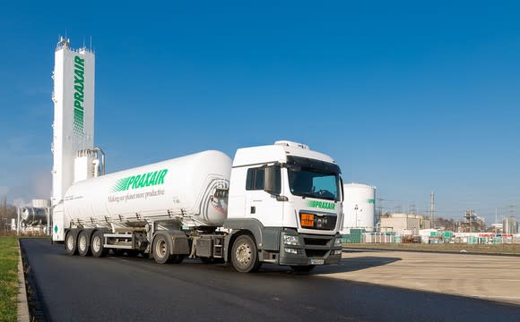 Semi tanker truck with Praxair markings on a road leaving a Praxair production facility.