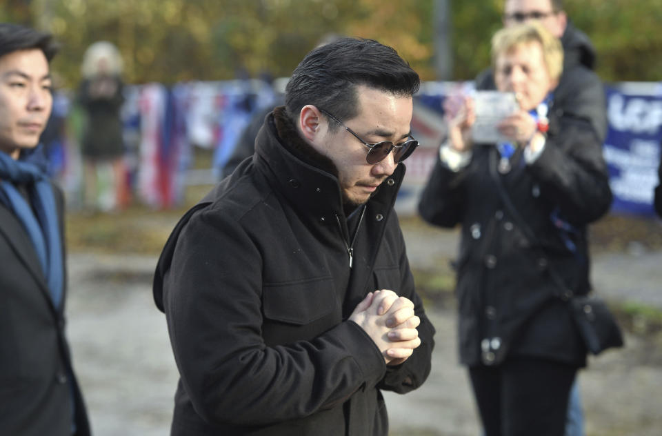 Aiyawatt Srivaddhanaprabha, views floral tributes for those who lost their lives in the Leicester City helicopter crash including Leicester City Chairman Vichai Srivaddhanaprabha ahead of the English Premier League soccer match at the King Power Stadium, Leicester, England. Saturday Nov. 10, 2018. (Joe Giddens/PA via AP)