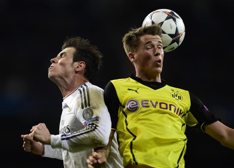 Real Madrid's Gareth Bale (left) vies with Borussia Dortmund's Erik Durm during their Champions League quarter-final first leg match at the Santiago Bernabeu stadium in Madrid, on April 2, 2014. Real Madrid won 3-0