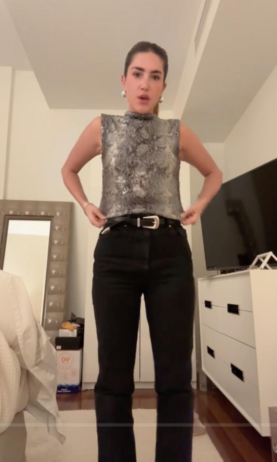 a woman wearing a top talking in a tiktok