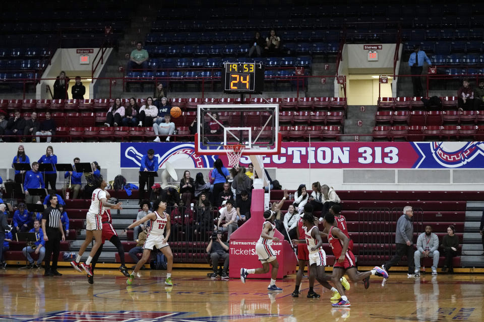 The Detroit Mercy team plays against Youngstown State during an NCAA college basketball game, Thursday, Jan. 12, 2023, in Detroit. Guard Antoine Davis, the nation's leading scorer is playing his fifth year for a team lacking in fan support. Davis entered the transfer portal to potentially finish his college career and was tempted to leave an overlooked basketball program for a major one. He had the green light to go to Maryland, Georgetown, Kansas State or BYU but chose stay despite a lack of fan support at games. (AP Photo/Carlos Osorio)