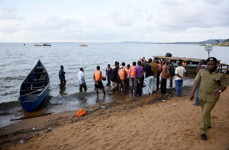 Rescue and recovery missions gather at the shores of Lake Victoria during the search for the bodies of dead passengers after a cruise boat capsized off Mukono district, Uganda November 25, 2018. REUTERS/Newton Nambwaya