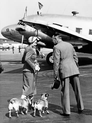 STRINGER/INTERCONTINENTALE/AFP via Getty Queen Elizabeth with her corgis, Susan and Sugar