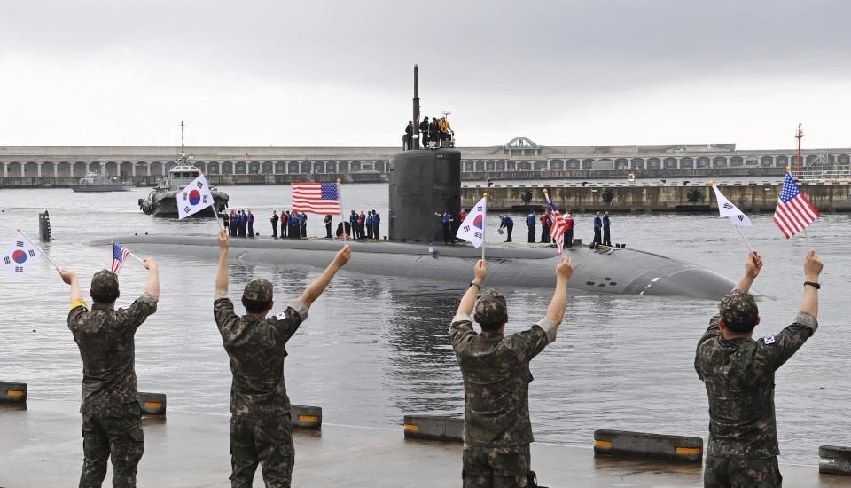 In this photo provided by South Korea Defense Ministry, South Korean navy sailors wave as the USS nuclear-powered submarine USS Annapolis arrives at a South Korean naval base on Jeju Island, South Korea, Monday, July 24, 2023. The nuclear-propelled U.S. submarine has arrived in South Korea in the second deployment of a major U.S. naval asset to the Korean Peninsula this month, South Korea's military said Monday, adding to the allies' show of force to counter North Korean nuclear threats. (South Korea Defense Ministry via AP)