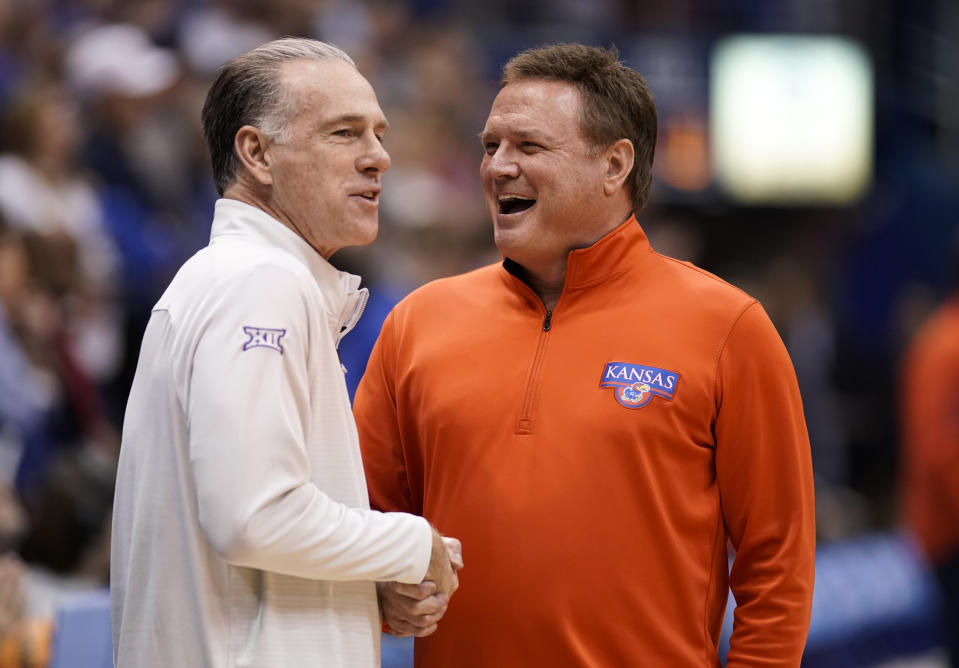 TCU head coach Jamie Dixon, left, and Kansas head coach Bill Self have a laugh before tipoff of an NCAA college basketball game on Saturday, Jan. 21, 2023, at Allen Fieldhouse in Lawrence, Kan. (AP Photo/Nick Krug)