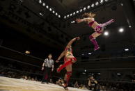 Wrestler Kaori Housako jumps at her opponent Mieko Satomura during a Stardom female professional wrestling show at Korakuen Hall in Tokyo, Japan, July 26, 2015. REUTERS/Thomas Peter