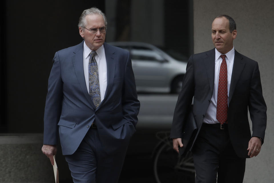 Pacific Gas and Electric Company (PG&E) CEO Bill Johnson, left, walks toward the California Public Utilities Commission headquarters before a meeting in San Francisco, Friday, Oct. 18, 2019. (AP Photo/Jeff Chiu)