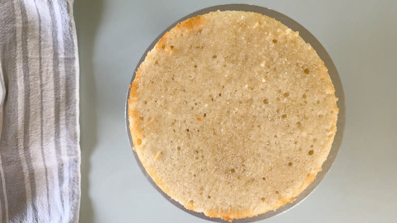 Top layer of Chantilly cream cake on cake stand